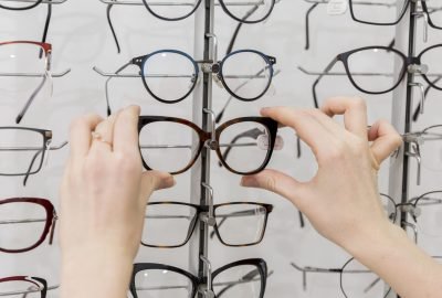 close-up-woman-hand-removing-eyeglasses-from-display